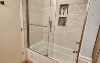 bathtub with glass shower doors